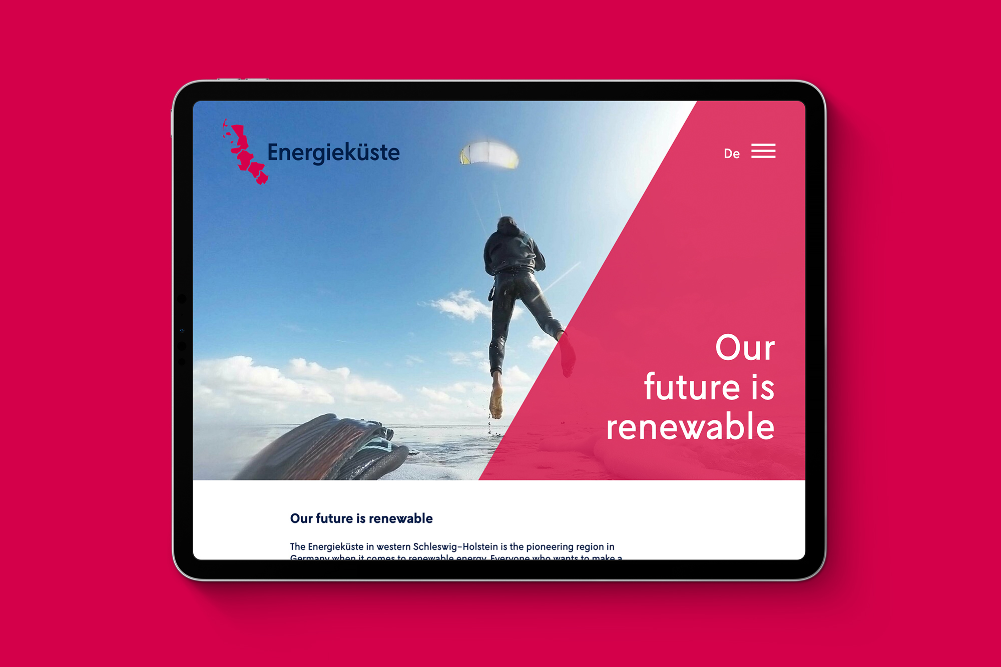 iPad on magenta background showing mobile version of Energy Coast website.