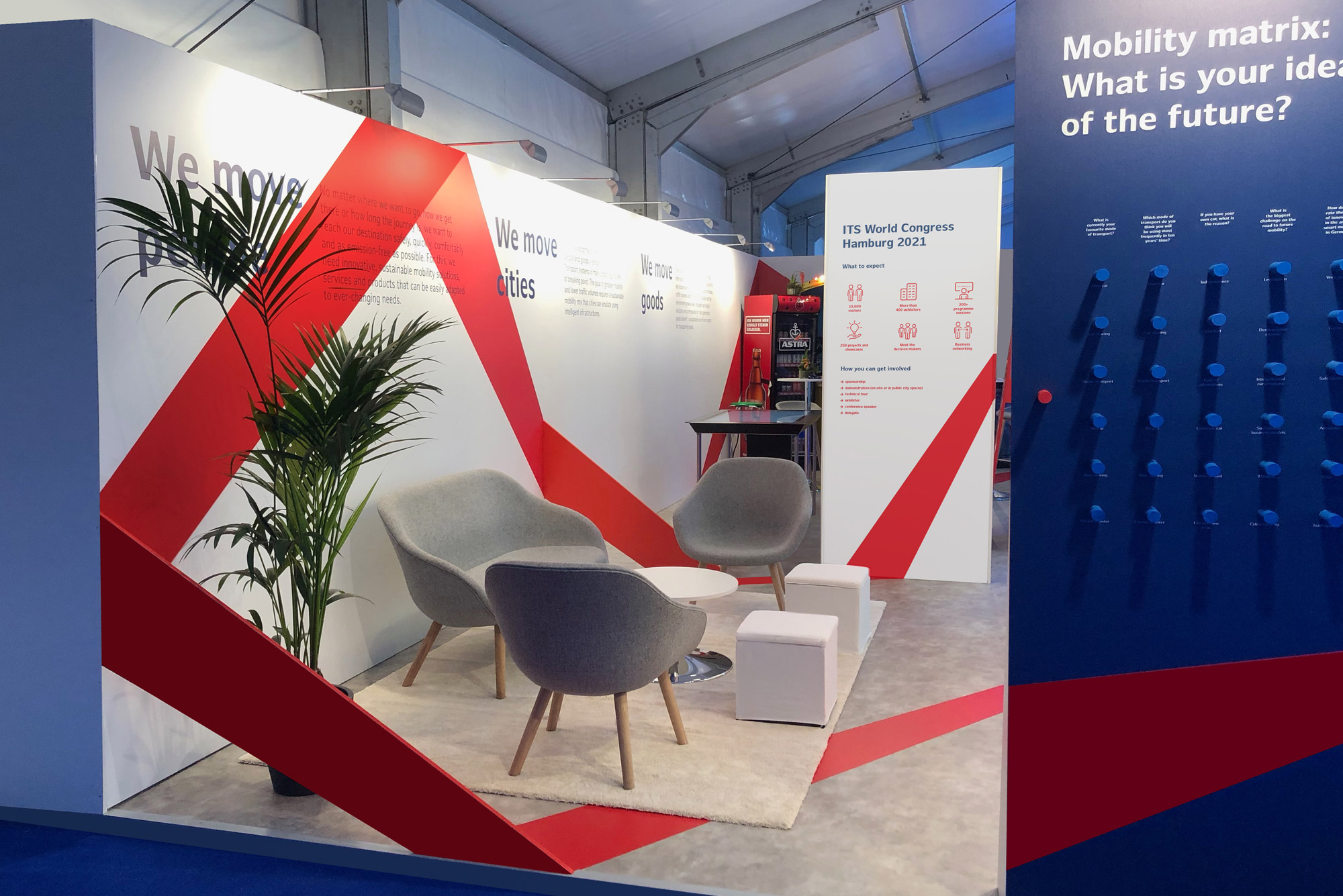 Photo of the ITS World Congress 2021 booth in blue and red with red ribbon as graphic element.